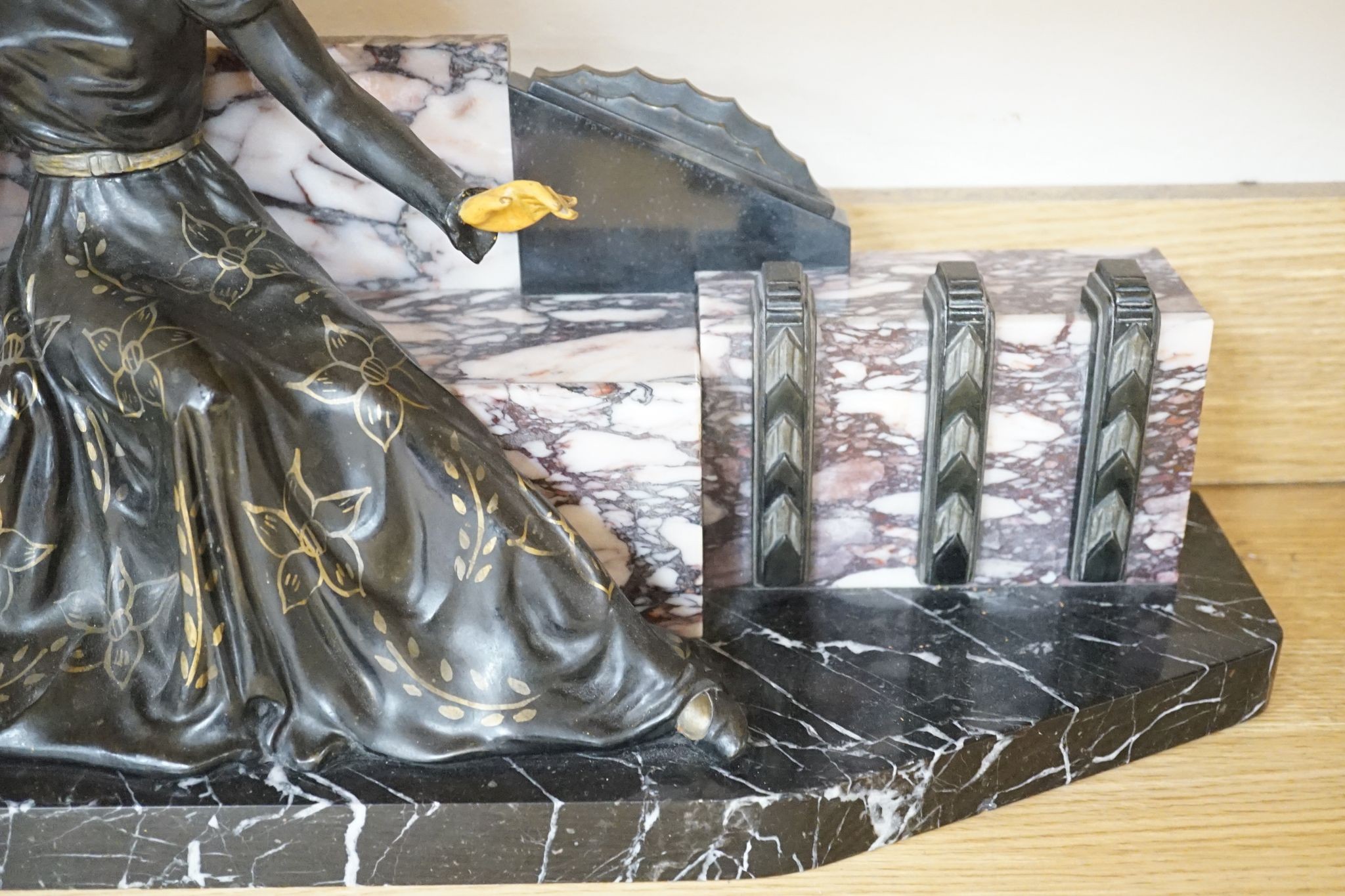 A large Art Deco style marble and spelter figural mantel ornament, 74 cms wide.